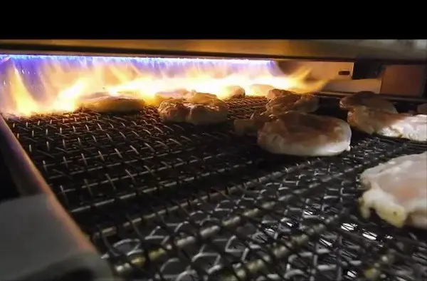 Raw chicken going into an Afoheat Flame Grill