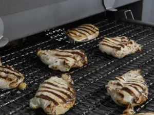 Chicken with grill marks coming out of a CircFood Infrared Grill