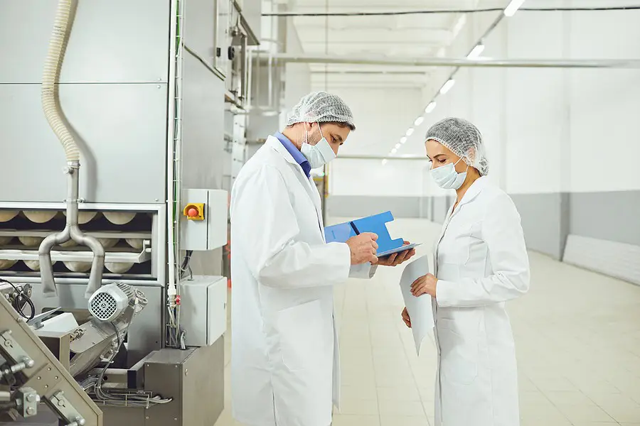 Food plant employees working through a checklist on efficiency