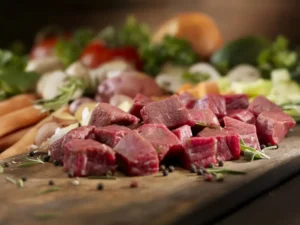 Beef cubes - diced - on a cutting board